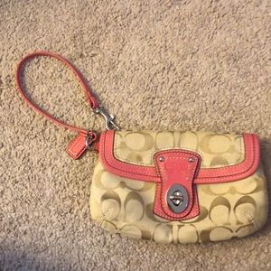Coral and tan Coach clutch